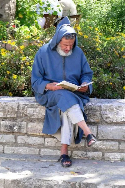 Maroko | Mieszkaniec Tangeru w tradycyjnej dżelabie przyłapany na lekturze